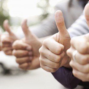 Human hands showing thumbs up sign
